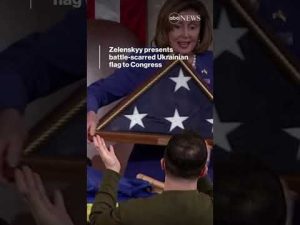 Read more about the article Zelenskyy presents battle-scarred Ukrainian flag to Congress