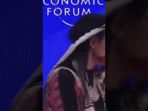 Read more about the article Native Woman Blows on WEF Panel Members