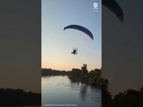 You are currently viewing Paraglider hits phone lines and plunges into river
