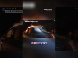 Read more about the article WATCH: Hero officers pull driver from burning car #shorts