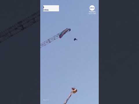Read more about the article Paraglider gets caught on giant construction crane in China