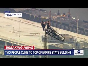 Read more about the article Two people climb to the top of Empire State Building spire, unfurl banner
